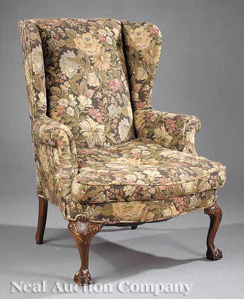 Appraisal: A Chippendale-Style Upholstered Wing Chair shaped back scrolled arms loose