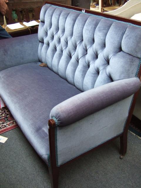 Appraisal: An Edwardian mahogany framed two seater sofa with button back