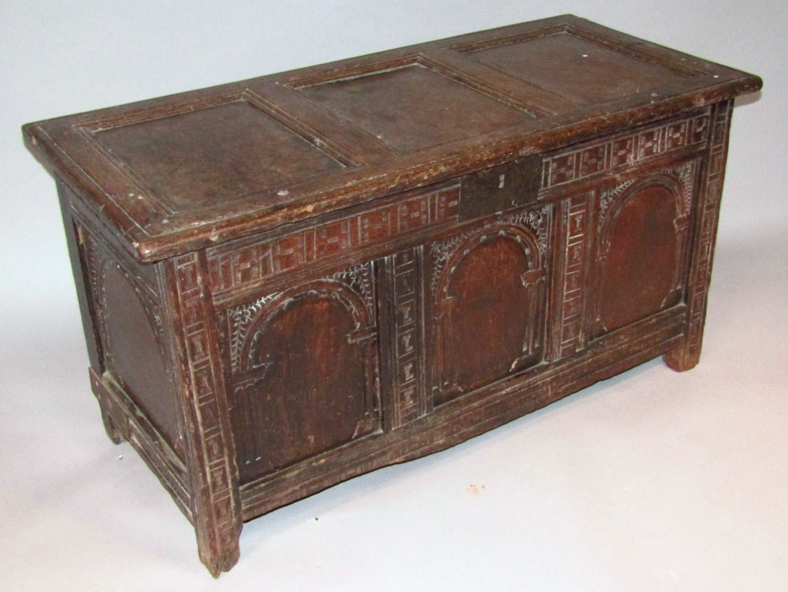 Appraisal: An early thC oak three panelled coffer the overhanging rectangular