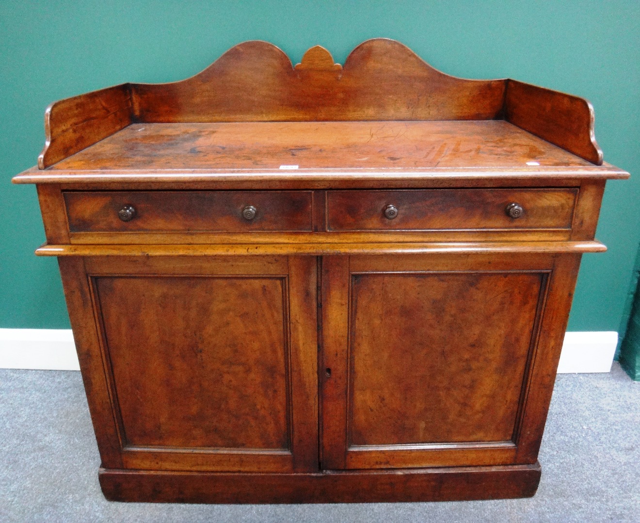 Appraisal: A th century mahogany side cabinet the shaped galleried back