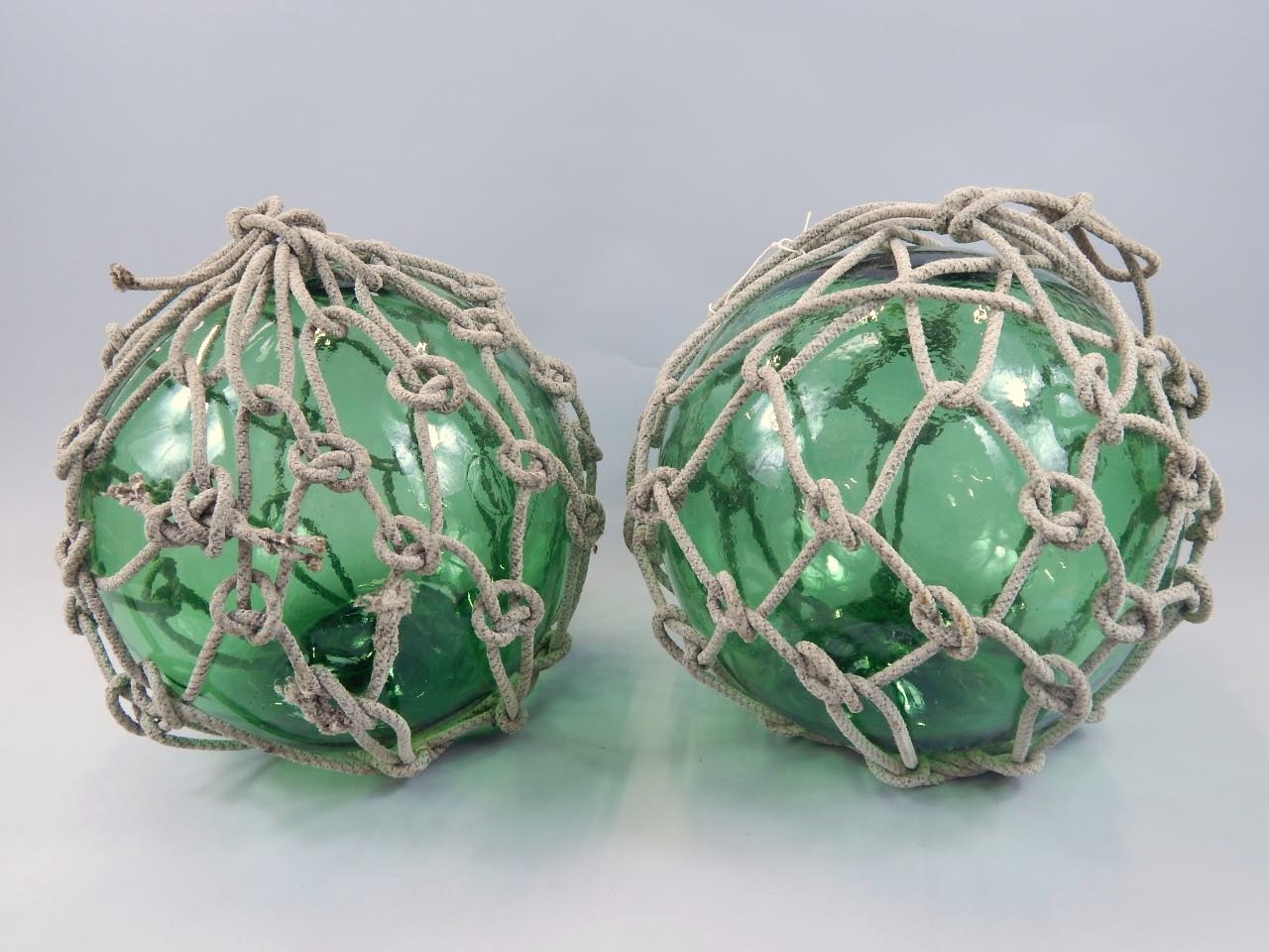 Appraisal: A pair of large size ships green glass net casts