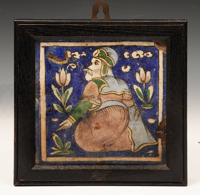 Appraisal: A QAJAR TILE on cobalt blue ground decorated with a