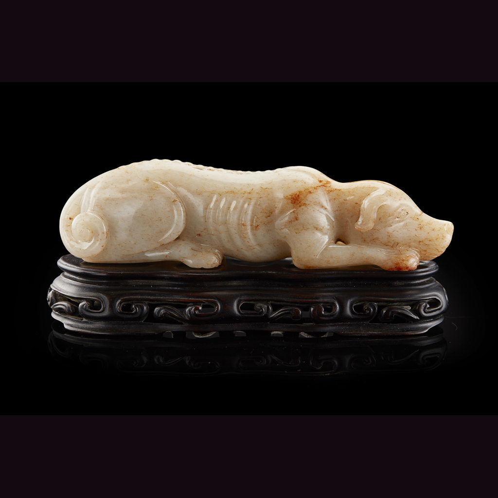 Appraisal: RECUMBENT WHITE JADE HOUND the head with eyes open gazing