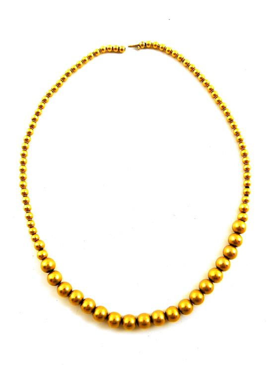 Appraisal: JEWELRY Graduated gold bead necklace tested K yellow gold l