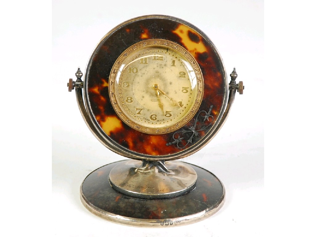 Appraisal: GEORGE V SILVER AND TORTOISESHELL REVOLVING DRESSING TABLE CLOCK the