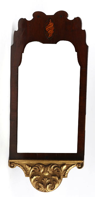 Appraisal: A GEORGIAN MAHOGANY VENEERED FRET FRAME WALL MIRROR with gilded