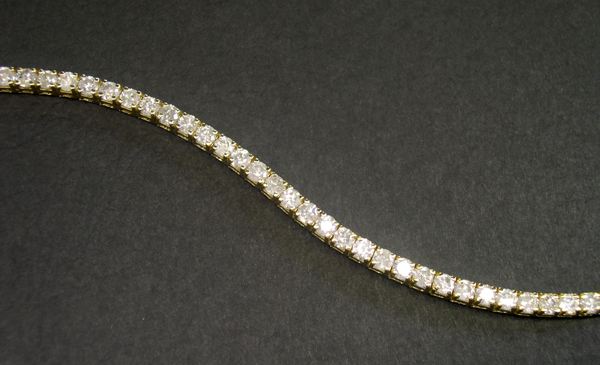 Appraisal: Fourteen-Karat Yellow Gold and Diamond Straight-Line Bracelet containing thirty-nine faceted