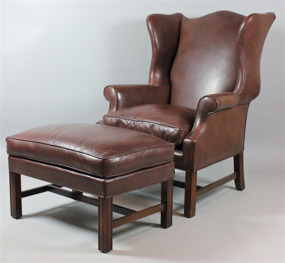 Appraisal: BROWN LEATHER CHIPPENDALE STYLE WING CHAIR AND OTTOMAN having an