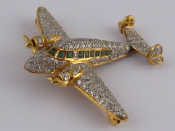 Appraisal: A pave set gold diamond and emerald brooch designed as