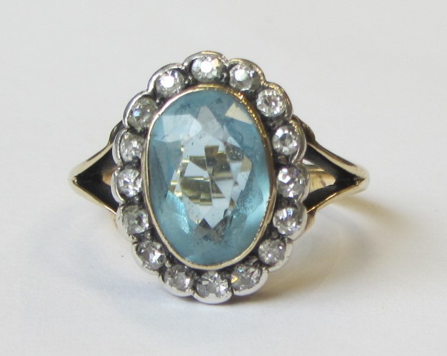 Appraisal: An aquamarine and diamond set oval cluster ring collet set