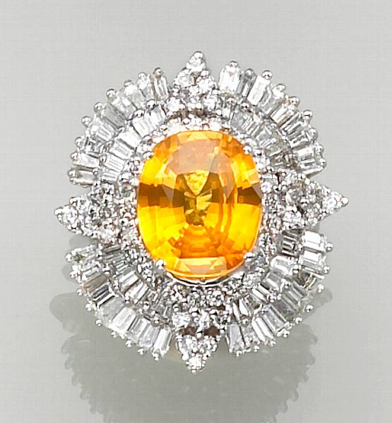 Appraisal: An orangy yellow sapphire diamond and fourteen karat white gold