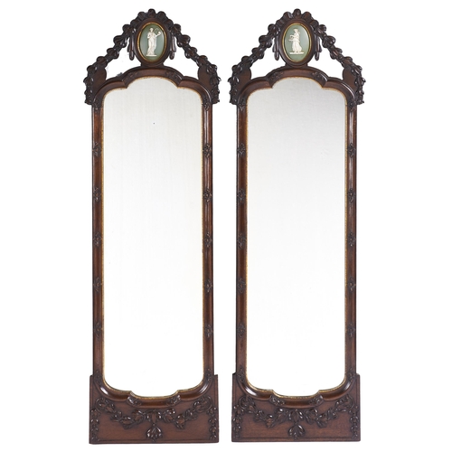 Appraisal: A pair of carved walnut mirrors early th c crested