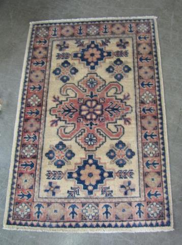 Appraisal: A handmade Oriental rug Kazak x cream with rose and