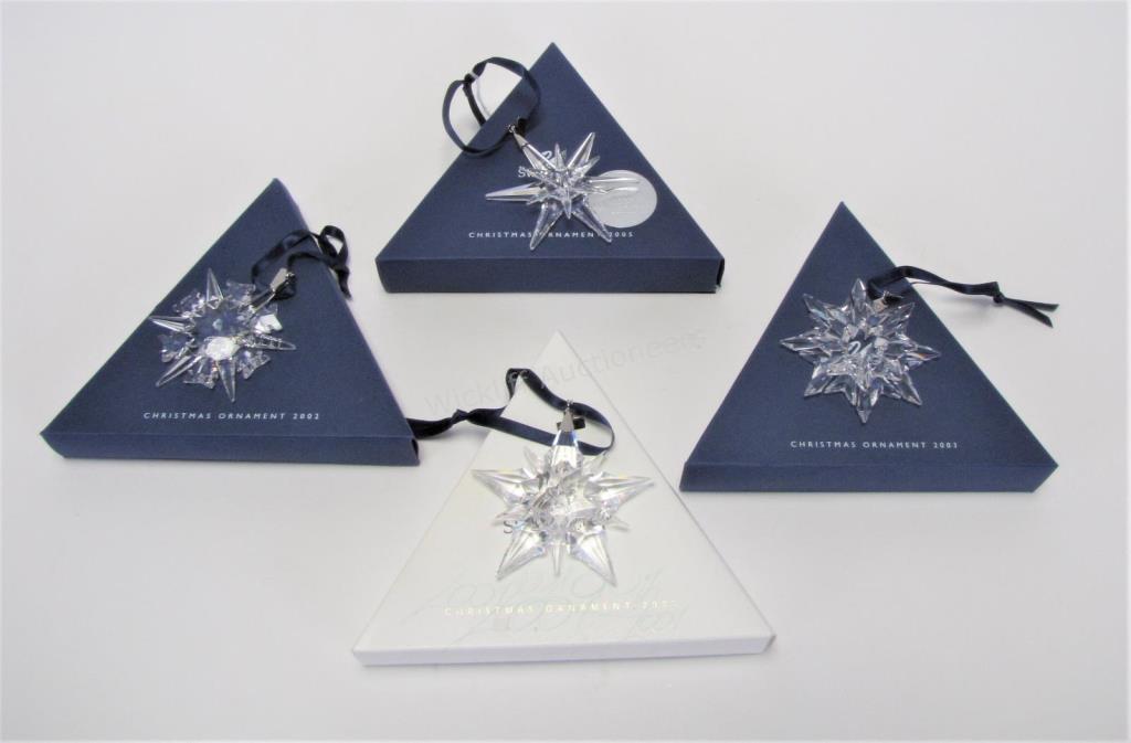 Appraisal: Four Swarovski crystal star ornaments including annual ornaments and all