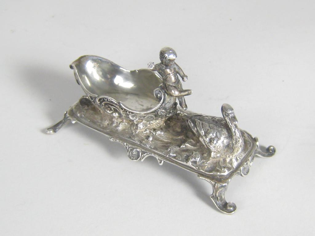 Appraisal: A Victorian Continental swan and cherub Salt on four scroll