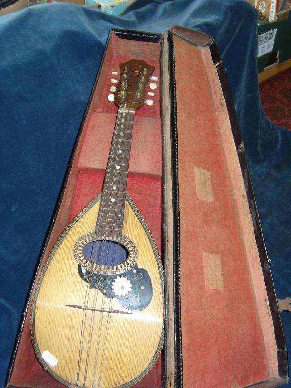 Appraisal: A cased mandolin with inlaid floral decoration