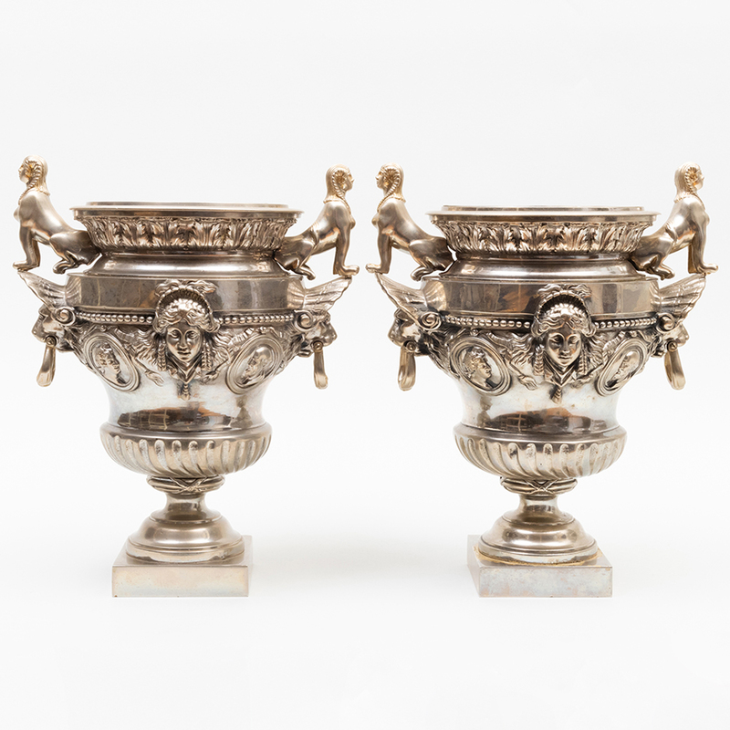 Appraisal: PAIR OF NAPOLEON III SILVERED-METAL URNS WITH SPHYNX HANDLES Unmarked