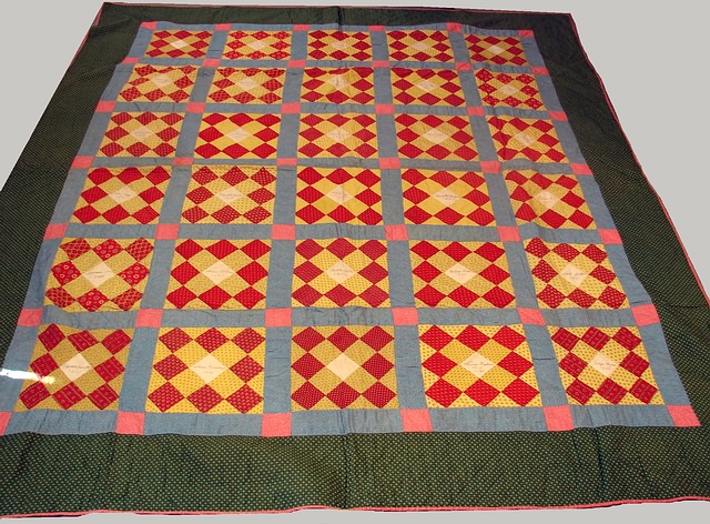 Appraisal: patchwork squares with small red and yellow patterned squares centering