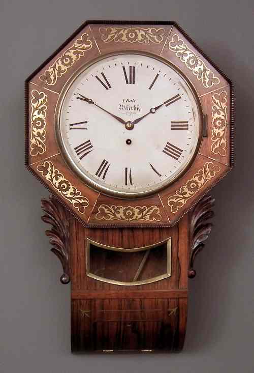 Appraisal: An early Victorian rosewood and brass inlaid drop dial wall