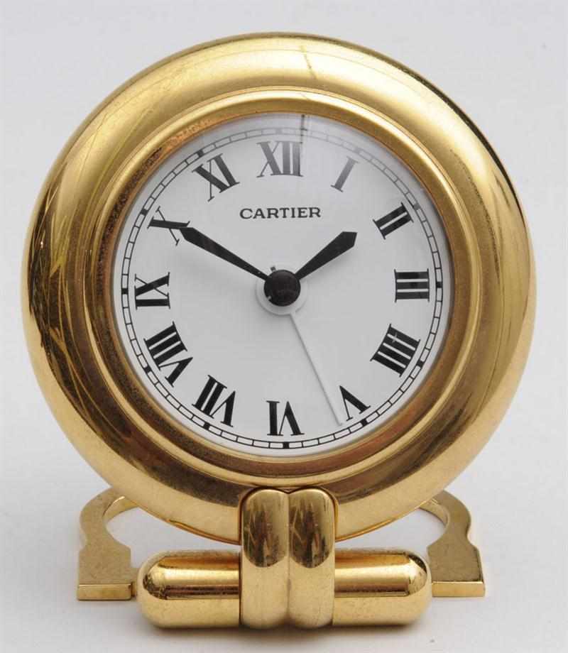 Appraisal: CARTIER BRASS TRAVEL CLOCK WITH FOLDING BUCKLE-FORM SUPPORT in diam