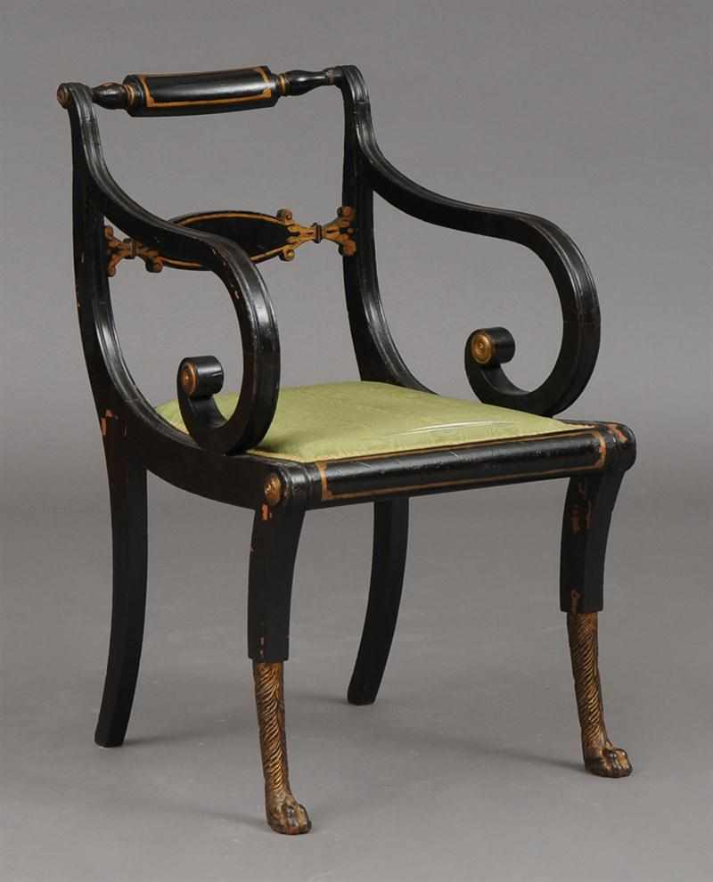 Appraisal: REGENCY STYLE BLACK-PAINTED AND PARCEL-GILT AMRCHAIR the curved top rail