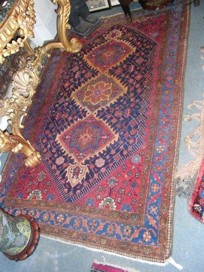 Appraisal: A HAMADAN BLUE GROUND RUG with three central panels within