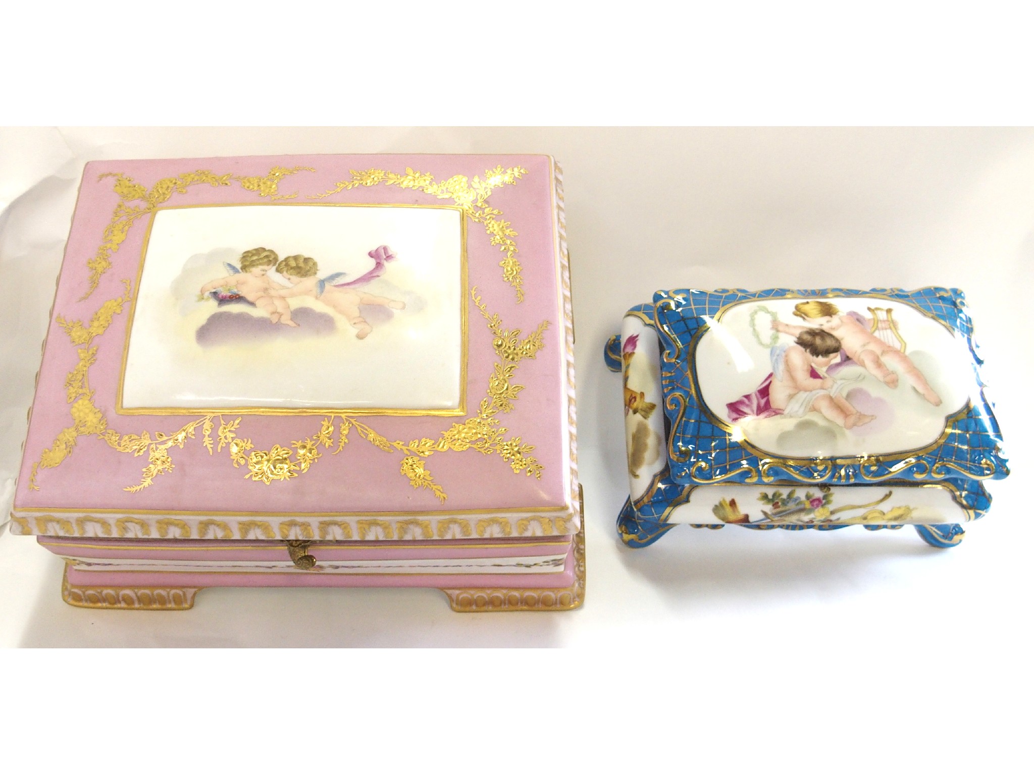 Appraisal: Porcelain table casket in pink and decorated with cherubs and