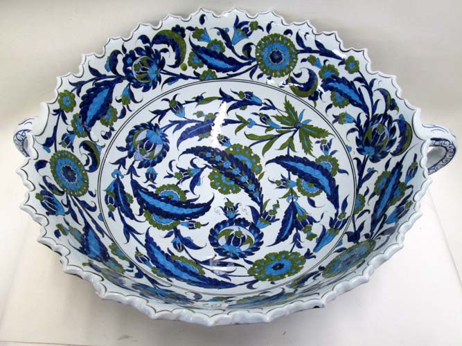 Appraisal: TURKISH IZNIK POTTERY BOWL WITH HANDLES hand enameled To Hold