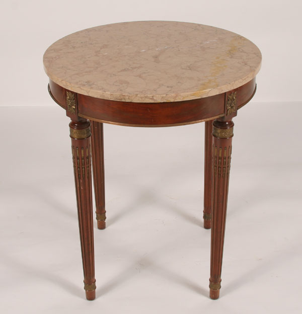 Appraisal: French style marble top table reeded legs and brass trim