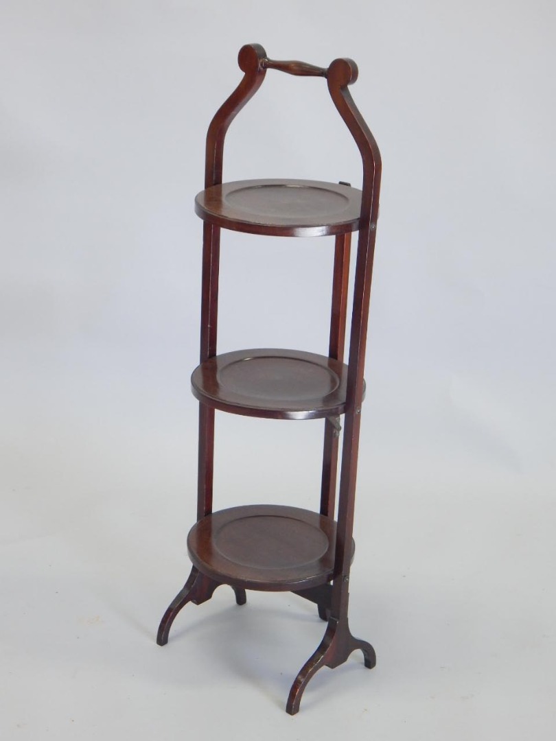 Appraisal: An early thC mahogany three tier cake stand on splayed