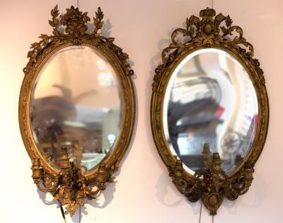 Appraisal: A near pair of gilt framed oval girandoles each with