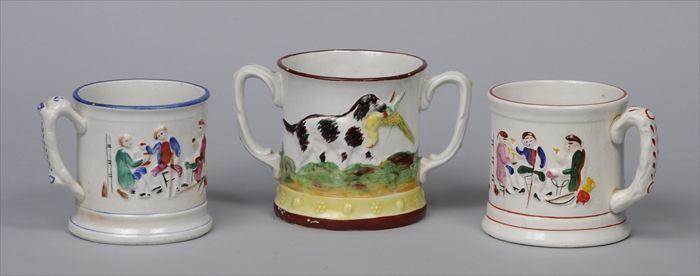 Appraisal: THREE STAFFORDSHIRE FROG MUGS Each with relief-molded decoration of a