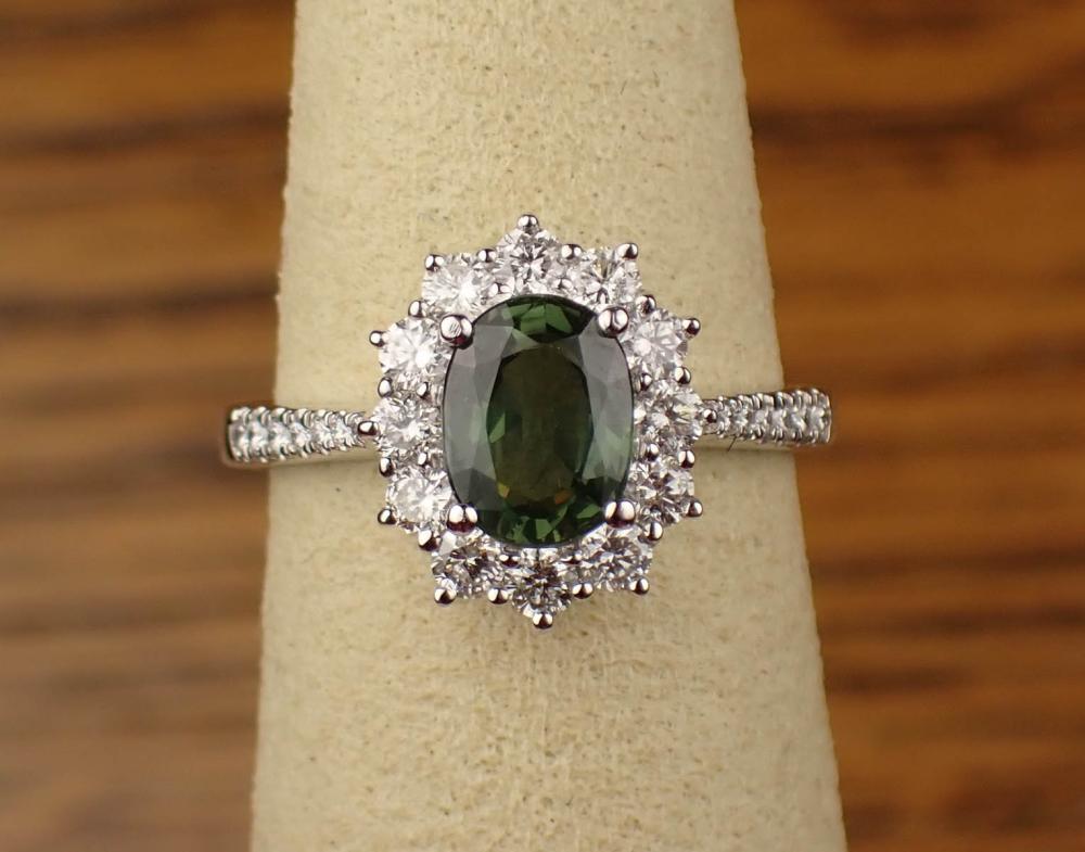 Appraisal: GREEN SAPPHIRE DIAMOND AND PLATINUM RING with round-cut diamonds set