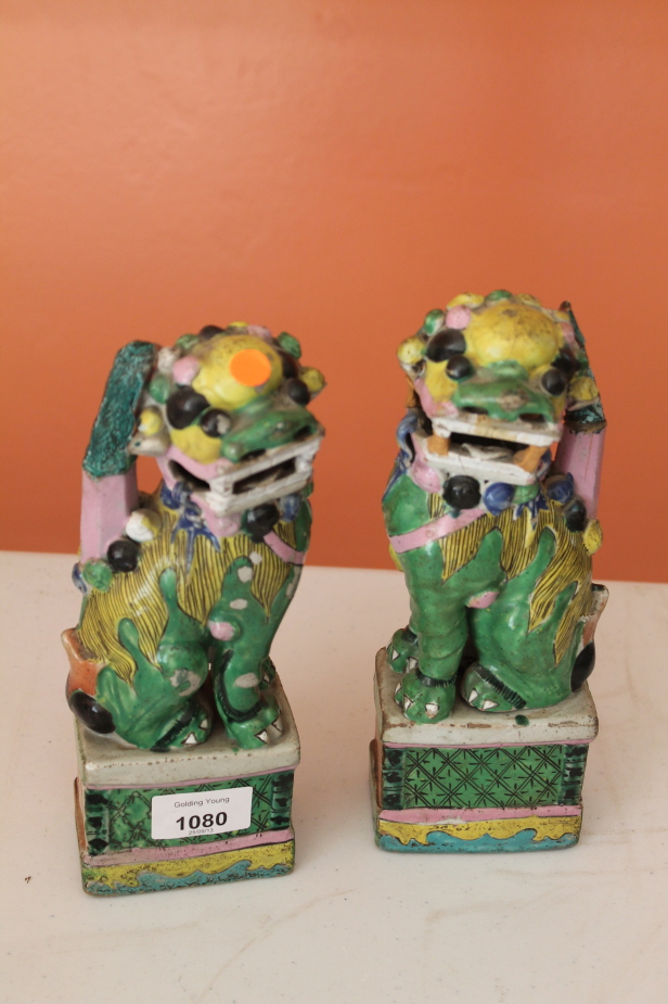 Appraisal: A pair of Chinese polychrome Dogs of Fo cm high