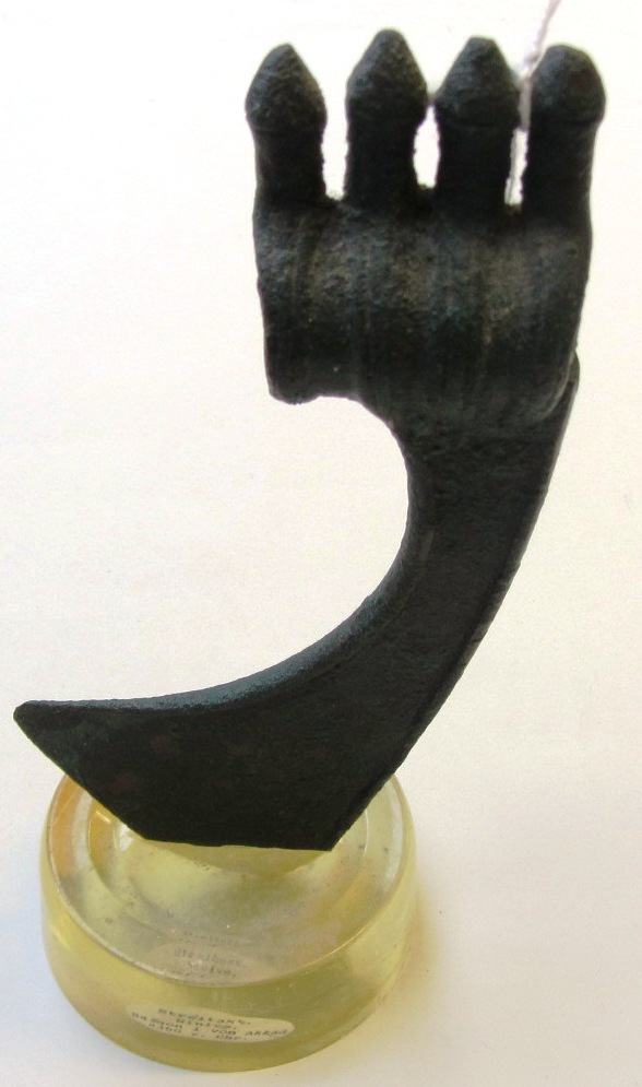 Appraisal: A Luristan bronze shaft-hole axe head with downward flaring blade