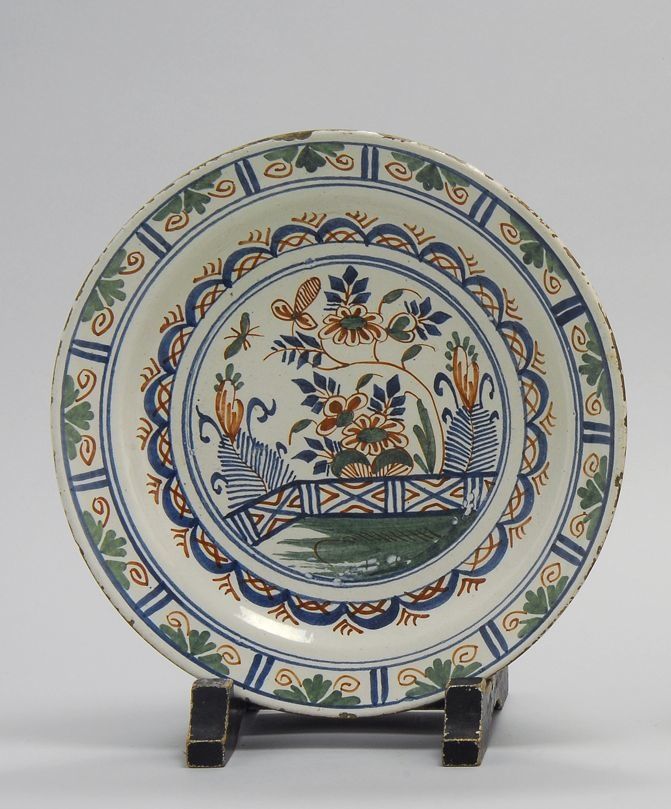 Appraisal: ENGLISH DELFT CHARGER Circa With central green blue and red