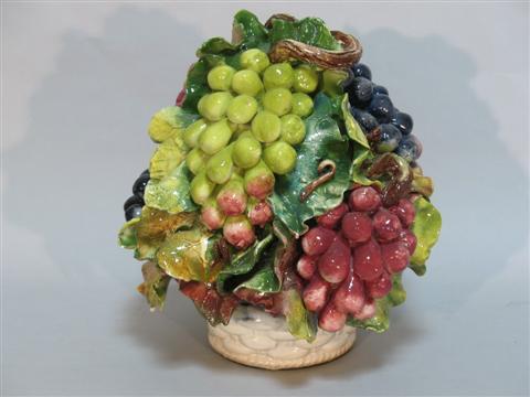 Appraisal: A POTTERY CENTERPIECE Modeled as branches of green red and