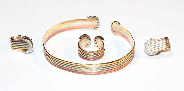 Appraisal: A CONTEMPORARY THREE COLOUR GOLD BRACELET with diamond set crescent