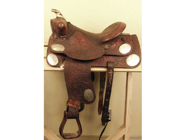 Appraisal: Textan western saddle with brown padded seat and floral stamped