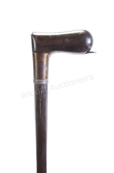 Appraisal: Shotgun Cane wood metal handle and shaft shaft unscrews to