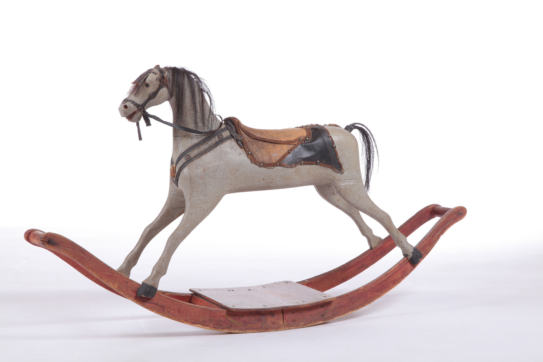 Appraisal: ROCKING HORSE American - mixed woods Folksy carved horse with