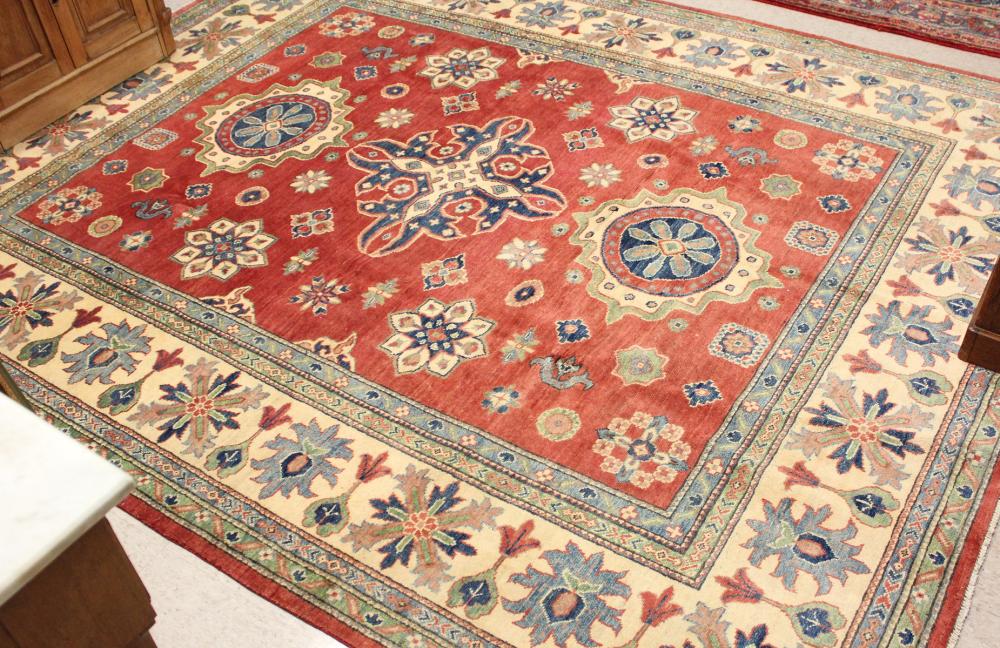 Appraisal: HAND KNOTTED ORIENTAL CARPET Pakistani-Caucasian medallions and other geometric elements