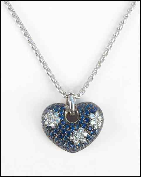 Appraisal: DIAMOND SAPPHIRE AND KARAT WHITE GOLD HEART PENDANT round diamonds