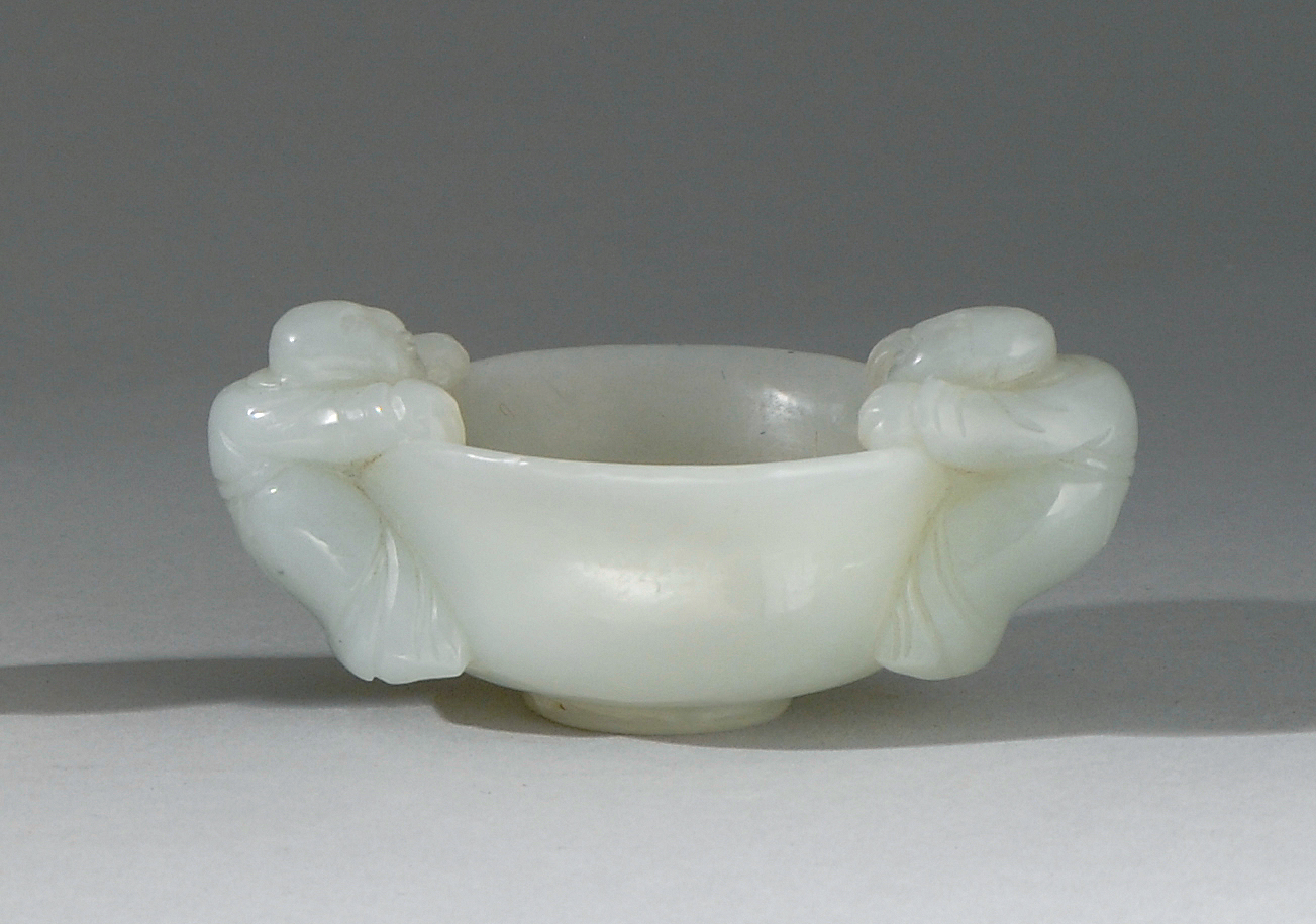 Appraisal: WHITE JADE HANDLED CUP th CenturyIn bell form with figural