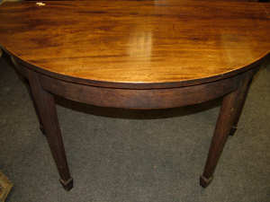 Appraisal: A mahogany dining table th century the d-end rounded top