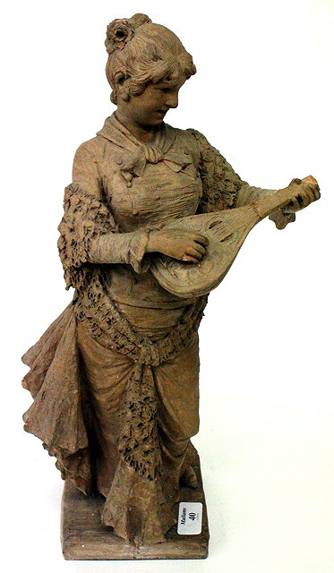 Appraisal: A TERRACOTTA STATUE OF A LADY PLAYING THE LUTE cm