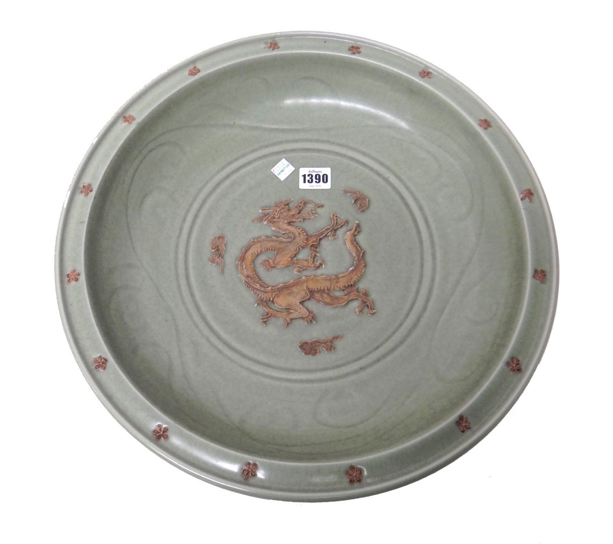 Appraisal: A large Chinese celadon glazed charger the centre moulded in