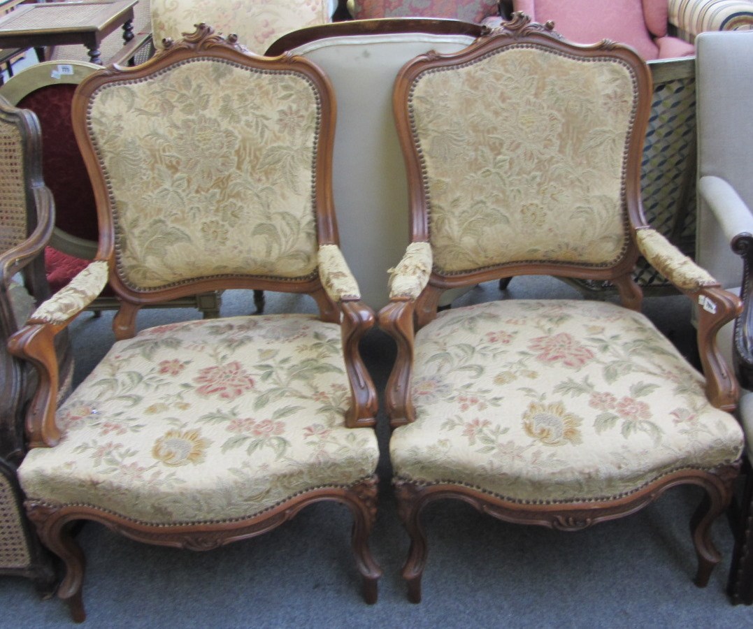 Appraisal: A pair of Louis XV style walnut framed fauteuils with