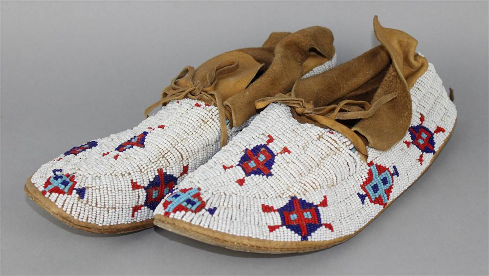 Appraisal: PAIR OF NATIVE AMERICAN BEADED HIDE MOCCASINS NORTHERN PLAINS ca