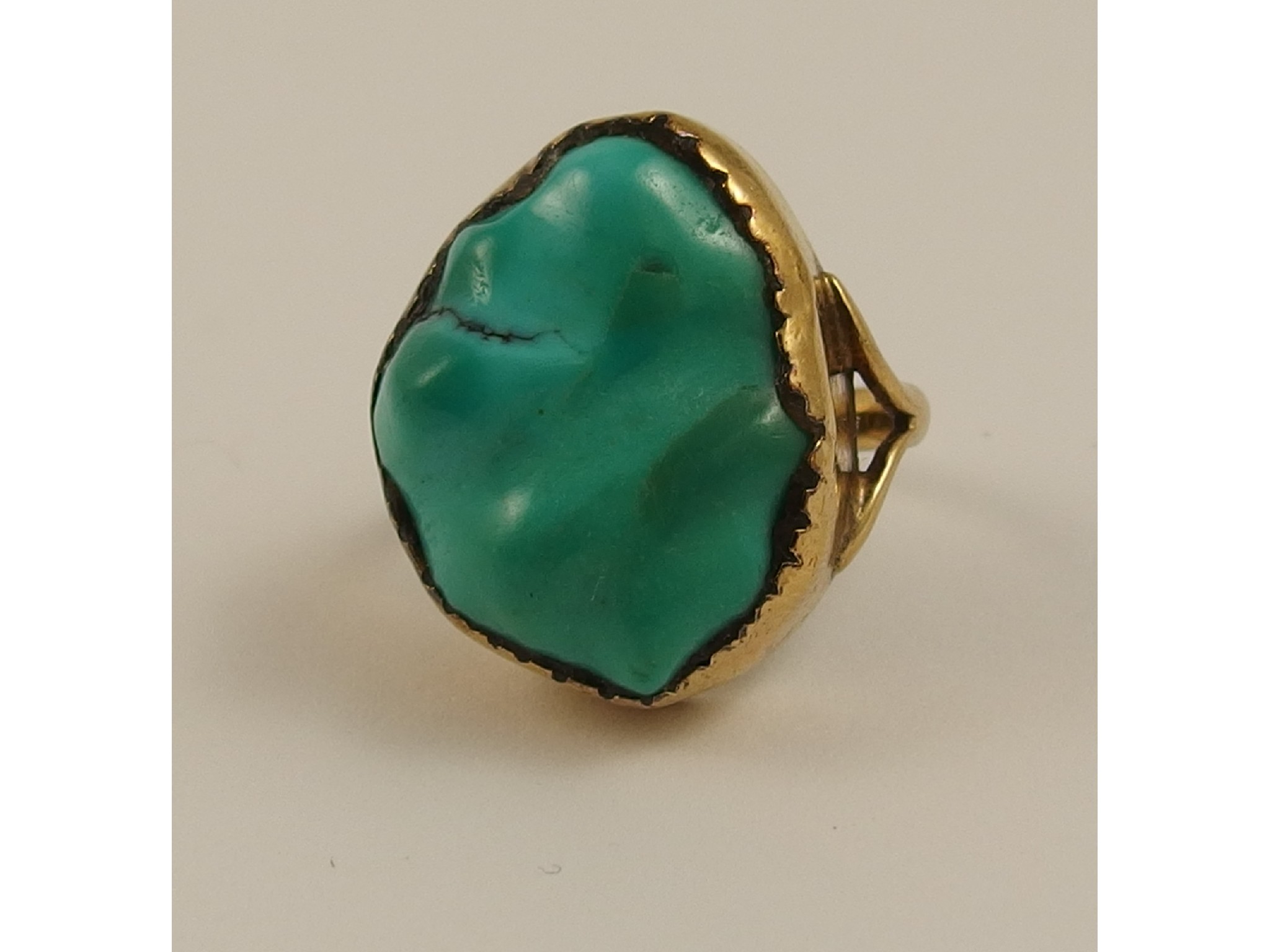 Appraisal: A yellow metal ring set with a large turquoise stone